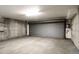 Unfinished garage with concrete walls and floor, and metal roll up garage door at 1390 S Idalia St # 39F, Aurora, CO 80017