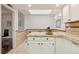 Bright kitchen with tiled countertops, backsplash and bar seating overlooking the dining area at 1390 S Idalia St # 39F, Aurora, CO 80017