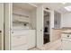 Bright laundry area featuring a white washer and dryer tucked away in a closet space with shelving at 1390 S Idalia St # 39F, Aurora, CO 80017