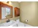 Bathroom features a classic white sink and toilet with light green walls and wooden cabinet at 3465 Beeler Ct, Denver, CO 80238