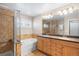 Bathroom featuring a glass shower, soaking tub, double sinks, and tile accents at 3465 Beeler Ct, Denver, CO 80238