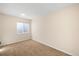 Empty bedroom featuring neutral paint, a window, and carpet at 3465 Beeler Ct, Denver, CO 80238