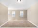 Bedroom with neutral walls, two bright windows, and carpet floors at 3465 Beeler Ct, Denver, CO 80238