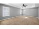 A spacious, carpeted bedroom has neutral paint, tray ceilings, and ample light at 3465 Beeler Ct, Denver, CO 80238