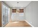 Bright dining area with a modern pendant light fixture, hardwood flooring, and sliding door at 3465 Beeler Ct, Denver, CO 80238