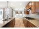 A modern kitchen features granite countertops, stainless steel appliances, and wood cabinetry at 3465 Beeler Ct, Denver, CO 80238