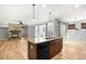 This open concept kitchen has an island, stainless steel appliances, and hardwood flooring at 3465 Beeler Ct, Denver, CO 80238