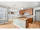 Bright kitchen with wooden cabinets, granite countertops, a center island, and hardwood flooring at 3465 Beeler Ct, Denver, CO 80238