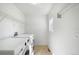 Bright laundry room with washer, dryer, shelving, and a window for natural light at 3465 Beeler Ct, Denver, CO 80238