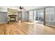 Bright living room with a stone fireplace, hardwood floors, and a sliding glass door to the patio at 3465 Beeler Ct, Denver, CO 80238