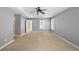 Spacious main bedroom features a tray ceiling, fan, and large windows at 3465 Beeler Ct, Denver, CO 80238