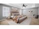 Spacious bedroom with tray ceilings, a ceiling fan, neutral paint, and ample natural light at 3465 Beeler Ct, Denver, CO 80238