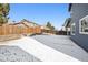Snow covered backyard with a wood fence between neighbors under a bright blue sky at 14441 E 102Nd Ave, Commerce City, CO 80022