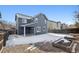 Back exterior of home featuring a patio, wood fence, and snow-covered backyard with garden at 14441 E 102Nd Ave, Commerce City, CO 80022