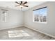 Bedroom with neutral walls, ceiling fan, and two large windows overlooking the neighborhood at 14441 E 102Nd Ave, Commerce City, CO 80022