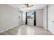 Bright bedroom featuring modern ceiling fan, light gray walls, and natural light with wood grain vinyl floors at 14441 E 102Nd Ave, Commerce City, CO 80022