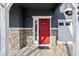 Close up on the red front door with stone accents and white trim at 14441 E 102Nd Ave, Commerce City, CO 80022