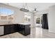 Kitchen with backyard views and sleek, black countertops at 14441 E 102Nd Ave, Commerce City, CO 80022