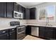 Close up on the stainless steel stove, oven, and sink area at 14441 E 102Nd Ave, Commerce City, CO 80022