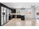 Well-lit kitchen featuring stainless steel appliances, dark cabinets, and light countertops at 14441 E 102Nd Ave, Commerce City, CO 80022