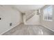 Bright living room featuring wood floors, large windows, and a staircase leading to the second floor at 14441 E 102Nd Ave, Commerce City, CO 80022