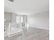 Bright living room area featuring stairs, hardwood floors, and a large window at 14441 E 102Nd Ave, Commerce City, CO 80022