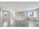 Spacious upper level living room with natural light, wood floors, and staircase leading to the lower level at 14441 E 102Nd Ave, Commerce City, CO 80022