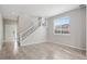 Bright living room featuring wood floors, large windows, and a staircase leading to the second floor at 14441 E 102Nd Ave, Commerce City, CO 80022