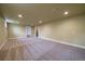 Large finished basement with neutral carpet, recessed lights, and access to the stairs at 6026 Iris Way, Arvada, CO 80004