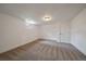 Finished basement with carpet, a single window, and a white door at 6026 Iris Way, Arvada, CO 80004