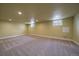 Spacious finished basement with neutral carpet, recessed lighting, and two small windows at 6026 Iris Way, Arvada, CO 80004