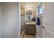Modern bathroom with wood-look vanity, stylish tile, and updated fixtures at 6026 Iris Way, Arvada, CO 80004