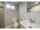 Bright bathroom with a white sink and toilet, with grey walls and patterned tile accents at 6026 Iris Way, Arvada, CO 80004