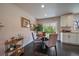 Dining area featuring a round table, comfortable seating, and a view to the backyard at 6026 Iris Way, Arvada, CO 80004
