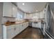 Bright kitchen featuring white cabinets, subway tile backsplash, butcher block counters and stainless steel appliances at 6026 Iris Way, Arvada, CO 80004