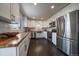 Bright kitchen with white cabinets, butcher block countertops, stainless steel appliances and hardwood flooring at 6026 Iris Way, Arvada, CO 80004