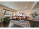 Bright and airy living room with large windows, a stylish rug, and comfortable seating at 6026 Iris Way, Arvada, CO 80004