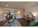 Open-concept living space with hardwood floors, seamlessly connecting the living room, dining area and kitchen at 6026 Iris Way, Arvada, CO 80004