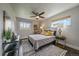 Cozy bedroom featuring a plush bed, stylish decor, and plenty of natural light at 6026 Iris Way, Arvada, CO 80004