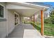 Covered patio with ample space for outdoor seating at 6026 Iris Way, Arvada, CO 80004