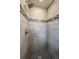 Modern shower featuring gray tiling and black, gray, and white accent stripe at 6026 Iris Way, Arvada, CO 80004