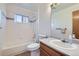 Bathroom featuring a tub and shower combination with a single vanity at 7075 Routt St, Arvada, CO 80004