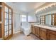 Bright bathroom with a double vanity, soaking tub, and glass-enclosed shower at 7075 Routt St, Arvada, CO 80004