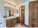 Bathroom with a double vanity sink and access to a closet at 7075 Routt St, Arvada, CO 80004