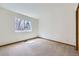 Bedroom with neutral carpet, a window, and white walls at 7075 Routt St, Arvada, CO 80004