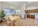 Open dining room and kitchen area with light wood floors and natural light at 7075 Routt St, Arvada, CO 80004