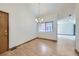Empty dining room featuring wood floors, a chandelier, and a window at 7075 Routt St, Arvada, CO 80004