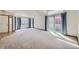 Spacious living room with large windows and a sliding glass door to the outside at 7075 Routt St, Arvada, CO 80004