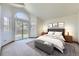 Cozy main bedroom with ample natural light, carpet floors, and deck access at 7075 Routt St, Arvada, CO 80004