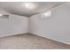Spacious carpeted basement with natural lighting, perfect for recreation or storage at 6131 Wolff St, Arvada, CO 80003